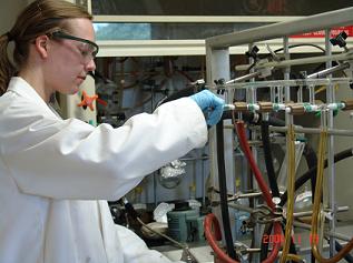 Taryn Campbell ´12 works in a lab, synthesizing compounds.