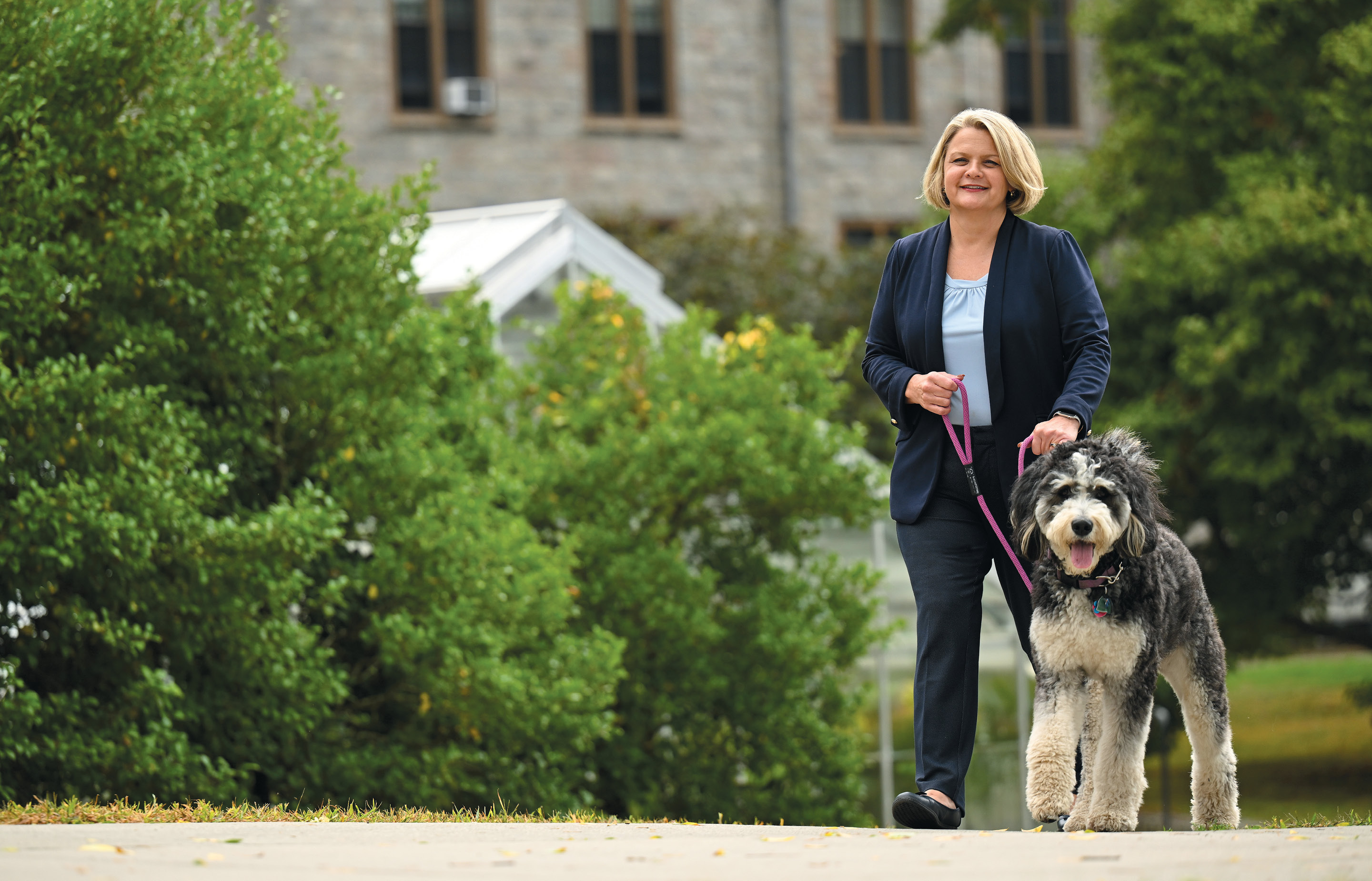 Image of President Chapdelaine walking her dog on Tempel Green