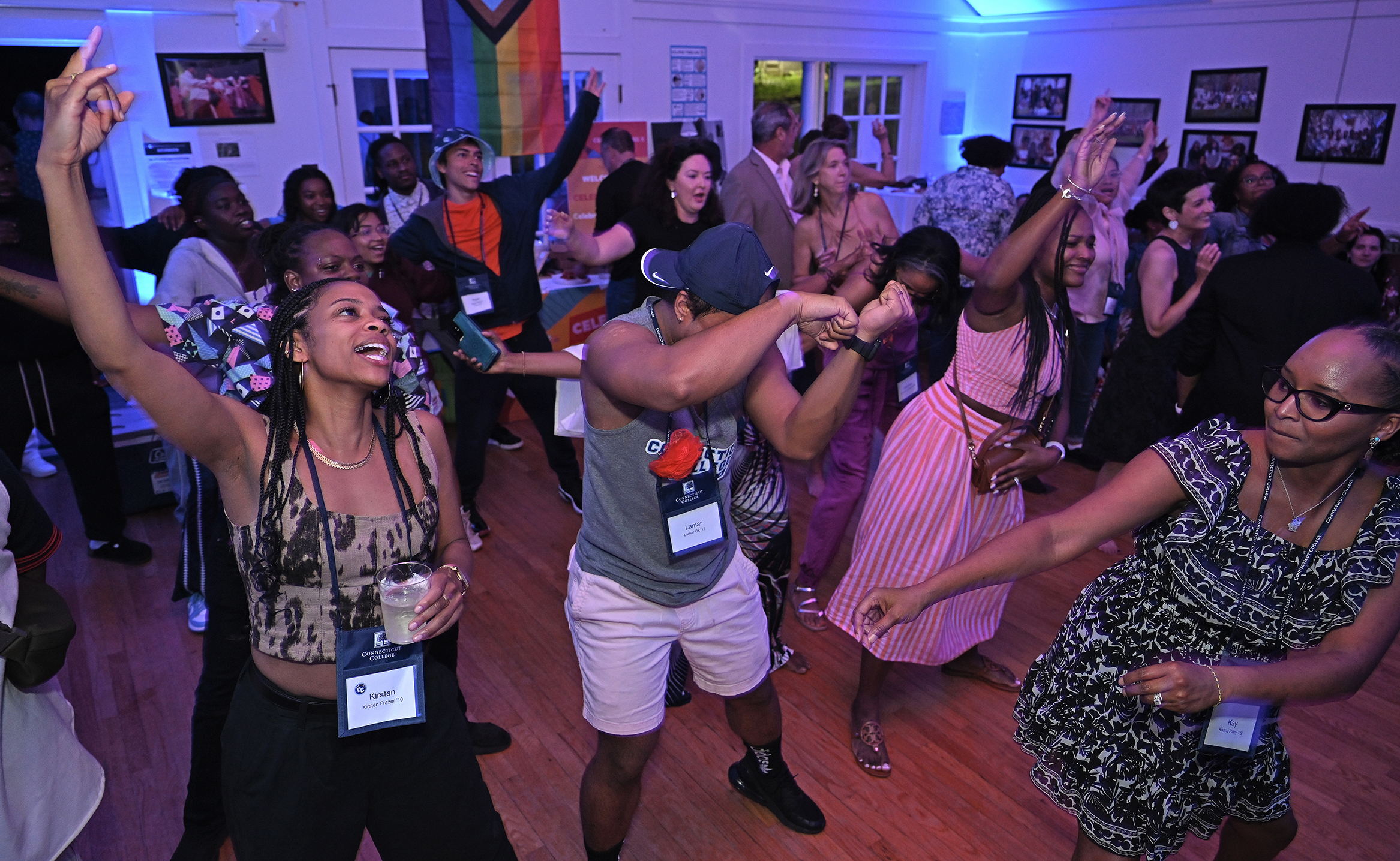 College alumni of color dance together during a reunion event