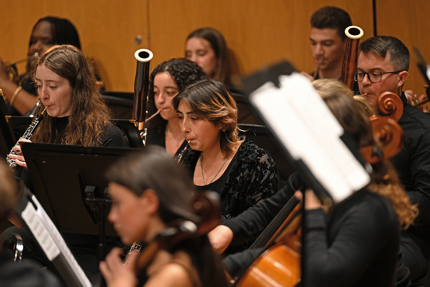 The woodwinds section of a student orchestra plays.